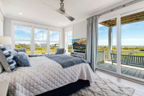 a bedroom with a bed and a balcony at Naut A Bad Gig in Oak Island