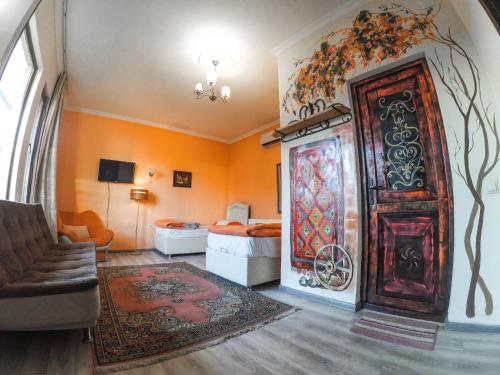 a room with a large wooden door and a bedroom at Batumi Wonderland in Batumi
