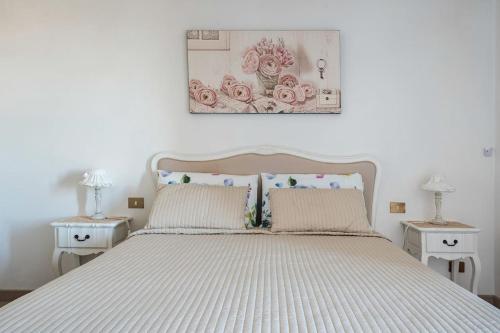 a bedroom with a white bed with two night stands at Fiesole is Magic in Fiesole