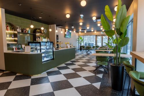 a bar in a restaurant with a checkered floor at Ring SPA Hostel in Tallinn