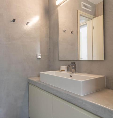 a bathroom with a white sink and a mirror at Breathtaking View Villa - Otzias in Korissia