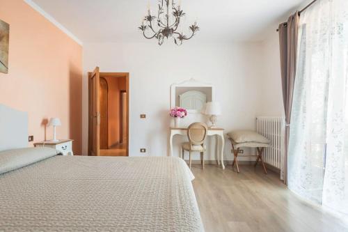 a bedroom with a bed and a table and a mirror at Fiesole is Magic in Fiesole