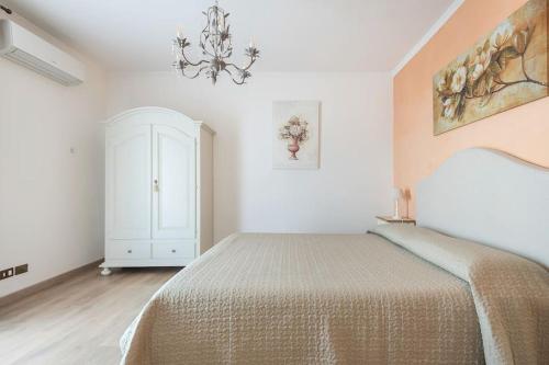 a bedroom with a bed and a chandelier at Fiesole is Magic in Fiesole
