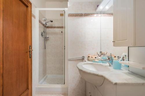 a bathroom with a shower and a sink and a tub at Fiesole is Magic in Fiesole