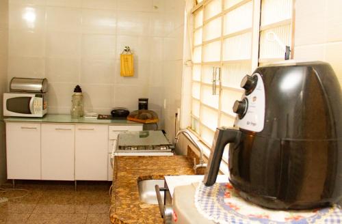 a kitchen with a appliance on a counter in a kitchen at Apartamento Gutierrez 1 in Belo Horizonte