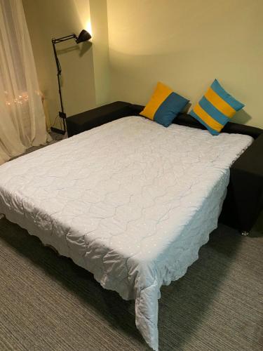 a large bed with pillows on it in a room at Bakuriani Kokhta Mitarbi Resort in Bakuriani
