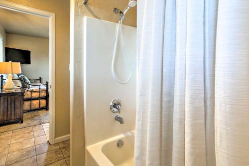 a bathroom with a shower and a bath tub at Stocked Grand Junction Home at Canyon View Park! in Grand Junction