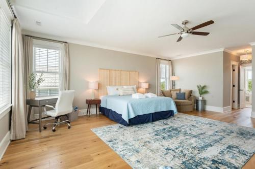 a bedroom with a bed and a desk and a computer at 1103 E Arctic - Salty Lady - Beautiful Custom Oceanfront Home - Hot tub in Folly Beach