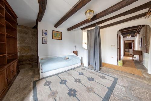 a large bedroom with a tub in the middle of a room at Casa da Guarda de Fora in Paredes