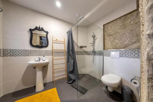 a bathroom with a sink and a toilet and a shower at Casa da Guarda de Fora in Paredes