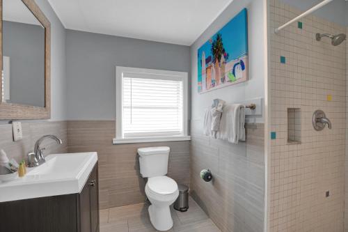 a bathroom with a white toilet and a sink at Seascape Resort & Marina in Marathon