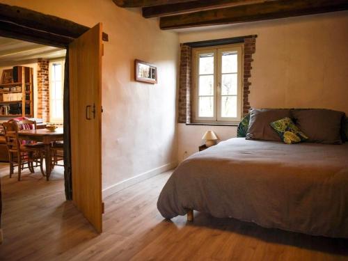 a bedroom with a bed and a dining room at Gîte Parassy, 2 pièces, 2 personnes - FR-1-586-31 