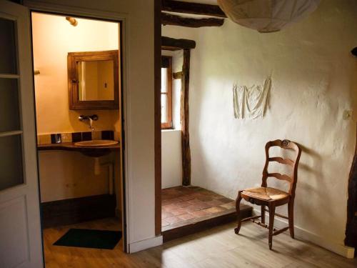 a room with a chair and a sink and a mirror at Gîte Parassy, 2 pièces, 2 personnes - FR-1-586-31 