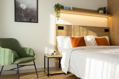 a bedroom with a bed and a chair at Be Casa - Rivas in Rivas-Vaciamadrid