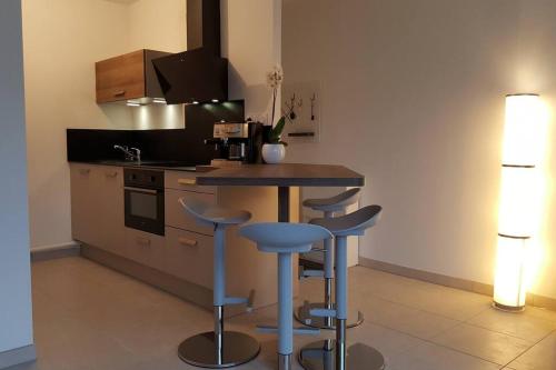 a kitchen with a counter and stools in a room at Kanoperoz-Plage de Trestraou in Perros-Guirec