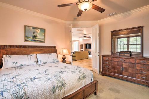 a bedroom with a bed and a ceiling fan at Riverfront Titusville Resort Home with Infinity Pool in Titusville