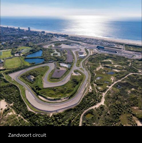 an aerial view of a road next to the ocean at Wellness bungalow with jacuzzi &sauna&private garden near Amsterdam in Vijfhuizen