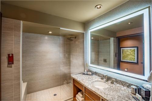 a bathroom with a sink and a large mirror at Choctaw Casino Resort - Durant in Durant