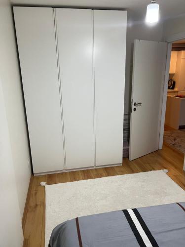 Pokój z 2 białymi szafkami i dywanem w obiekcie Full furnished Stylish Flat in Istanbul w Stambule