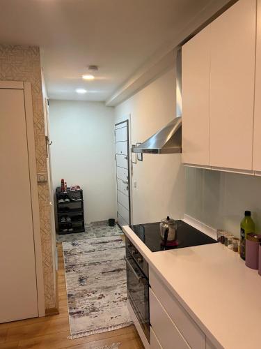 a kitchen with white cabinets and a counter top at Full furnished Stylish Flat in Istanbul in Istanbul