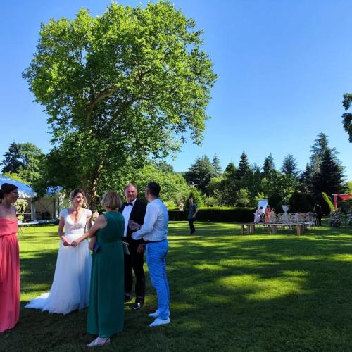 a group of people standing around in a park at CHATEAU DE BRINVILLE in Saint-Sauveur-sur-École