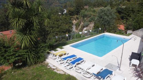 an overhead view of a swimming pool with lounge chairs at Casa da Loja in Vieira do Minho