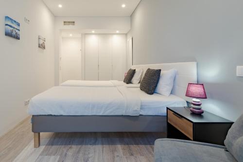 a bedroom with a large bed and a couch at Casa Dagan in Setúbal