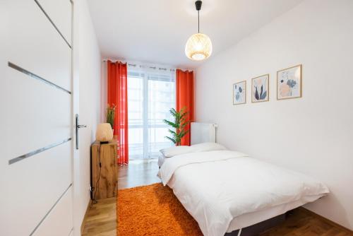 a bedroom with two beds and a window at Metro Bemowo Colourful Apartment in Warsaw