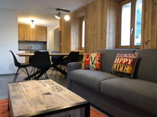 a living room with a couch and a table at The Rock House in Sion