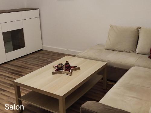 a living room with a coffee table and a couch at Mieszkanie blisko Targów Poznańskich in Poznań