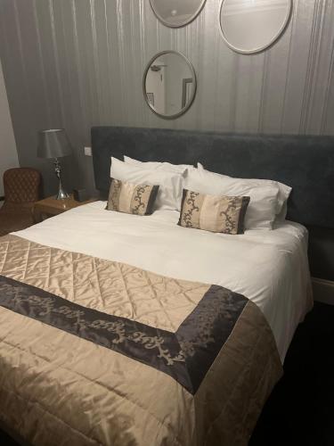 a bedroom with a large bed with two pillows at The Aberlour Hotel in Aberlour