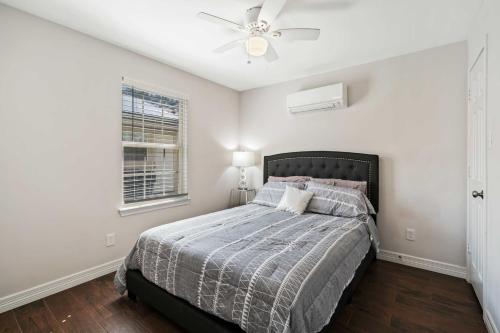 um quarto com uma cama e uma ventoinha de tecto em Stunning & Vibrant APT 7 Min From TX Med Center em Houston