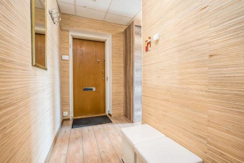 a hallway with a bench in front of a door at Lauteri Apart INN Free parking Self Check-In 24h in Tallinn