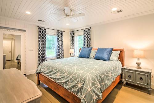 a bedroom with a bed with blue pillows at Sunset Cottage on Paukie Island with Private Dock! in Beaufort