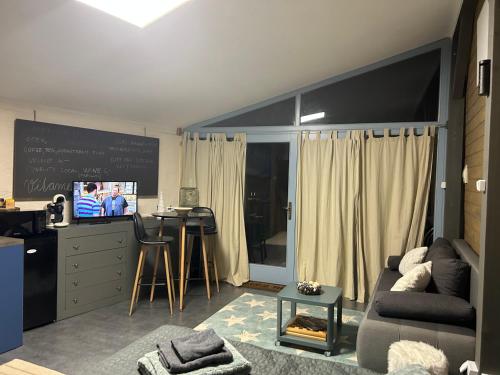 a living room with a couch and a chalkboard at MonPe apartmánik s atmosférou in Komárno
