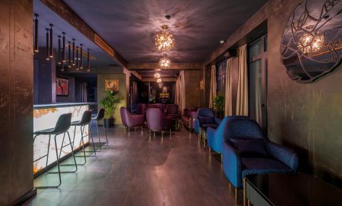 a bar with purple and blue chairs in a room at Onyx City Center in Tbilisi City