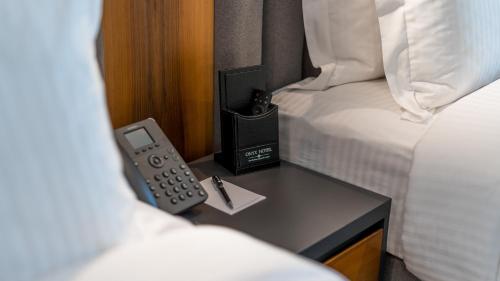 a room with two beds and a remote control on a table at Onyx City Center in Tbilisi City