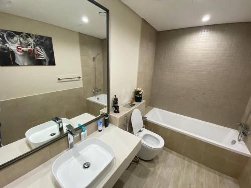 a bathroom with a sink and a toilet and a tub at Feel home ! Away from home in Dubai