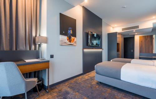 a hotel room with two beds and a desk and a bed sidx sidx sidx sidx at Onyx City Center in Tbilisi City