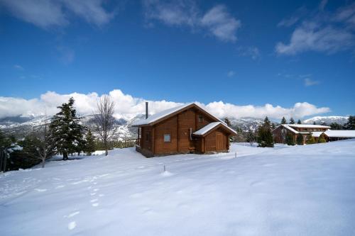 a small wooden cabin in the snow with snow at The Flysch in Miríki