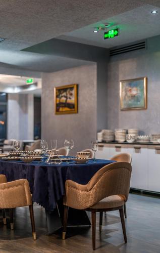 a dining room with a blue table and chairs at Onyx City Center in Tbilisi City