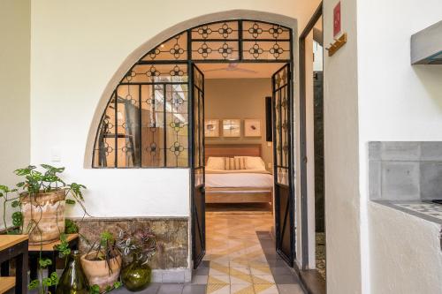 a hallway with an archway with a bed in a room at Casa Mateo in Guadalajara