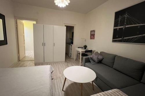uma sala de estar com um sofá e uma mesa em Kallion helmi em Helsinque