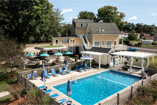 an overhead view of a pool with chairs and umbrellas at Admiral's Inn Resort in Ogunquit
