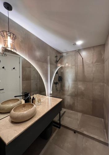 a bathroom with two sinks and a shower at Winter Flat - Orange Ski in Gudauri