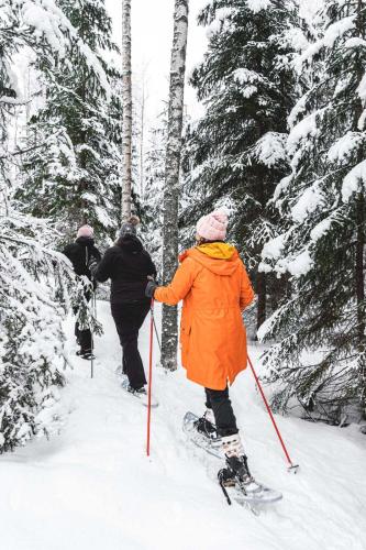 a group of people on skis in the snow at Venejoen Piilo - Päre in Kontiolahti