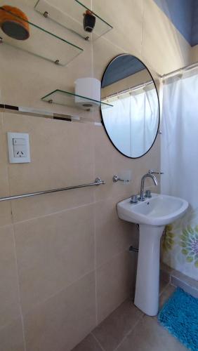 a bathroom with a sink and a mirror at Cabañas Laureano AJ in Cacheuta