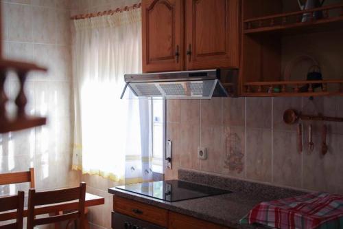 a kitchen with a stove and a counter top at Casa Fundo de Vila in Manteigas