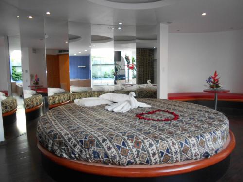 a bedroom with a large bed in a room at GS Cuernavaca Drive Inn - Adults Only in Cuernavaca