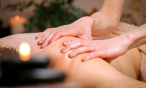 a woman getting a massage on her back at Casa Hibiscus Marbella in Marbella